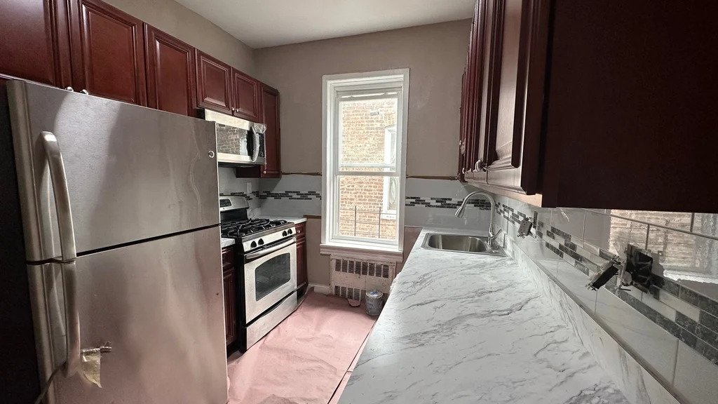 Kitchen in a Brooklyn best deal apartment with stainless steel appliances