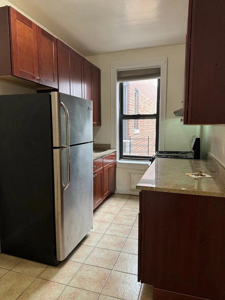 Kitchen with stainless steel appliances in Queens apartment