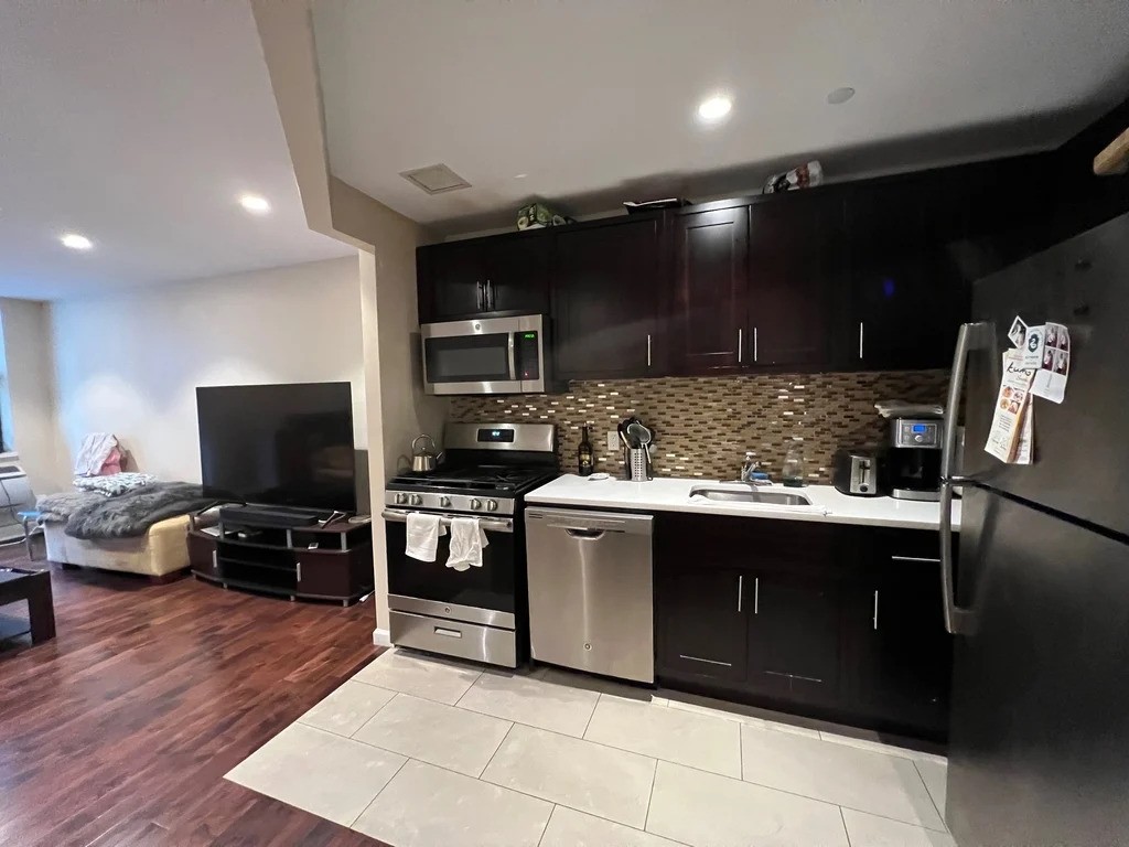 Brooklyn apartment with dark cabinets in the kitchen