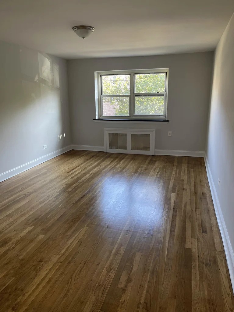 Living room with large window in Queens