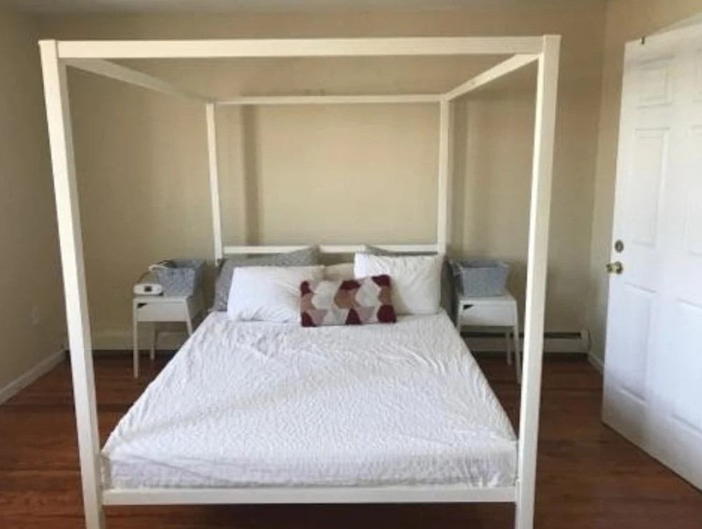 Bedroom with a canopy bed in a Queens apartment