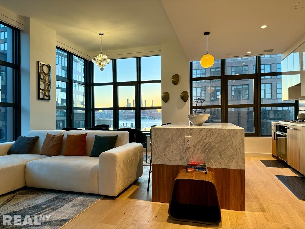 Oversized living room with windows overlooking Manhattan