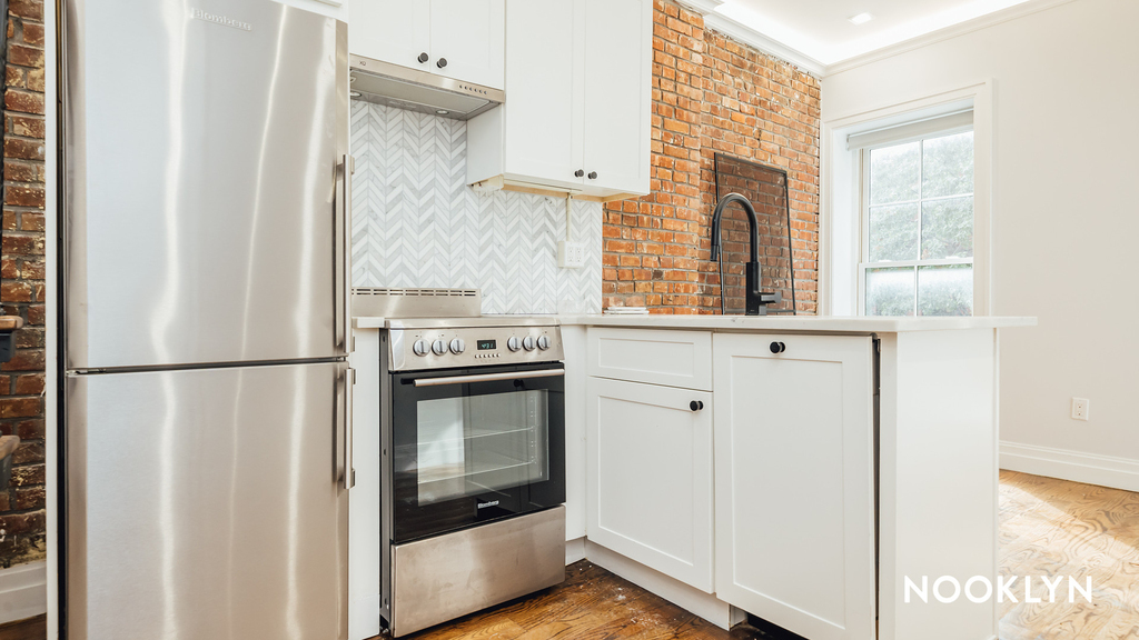 Living room and kitchen with exposed brick near ferry stop