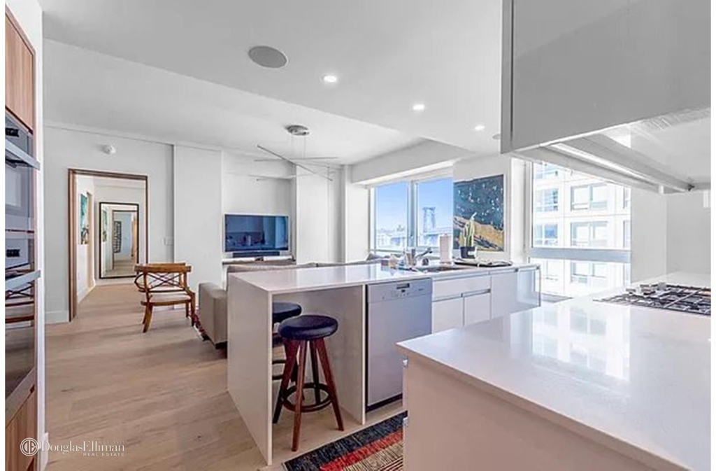 Open-concept kitchen and living area with recessed lighting