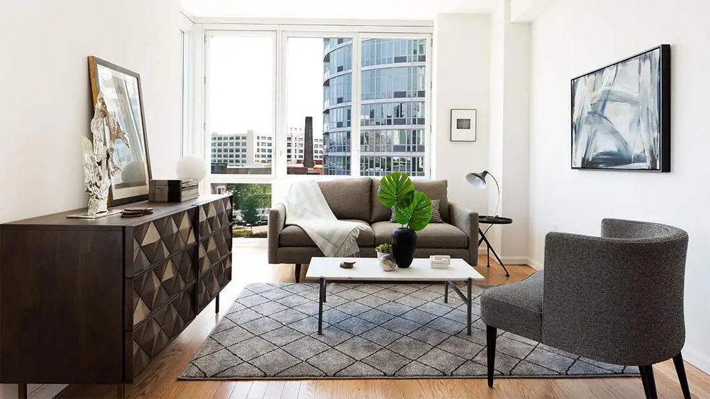 Living room with oversized window near a ferry stop