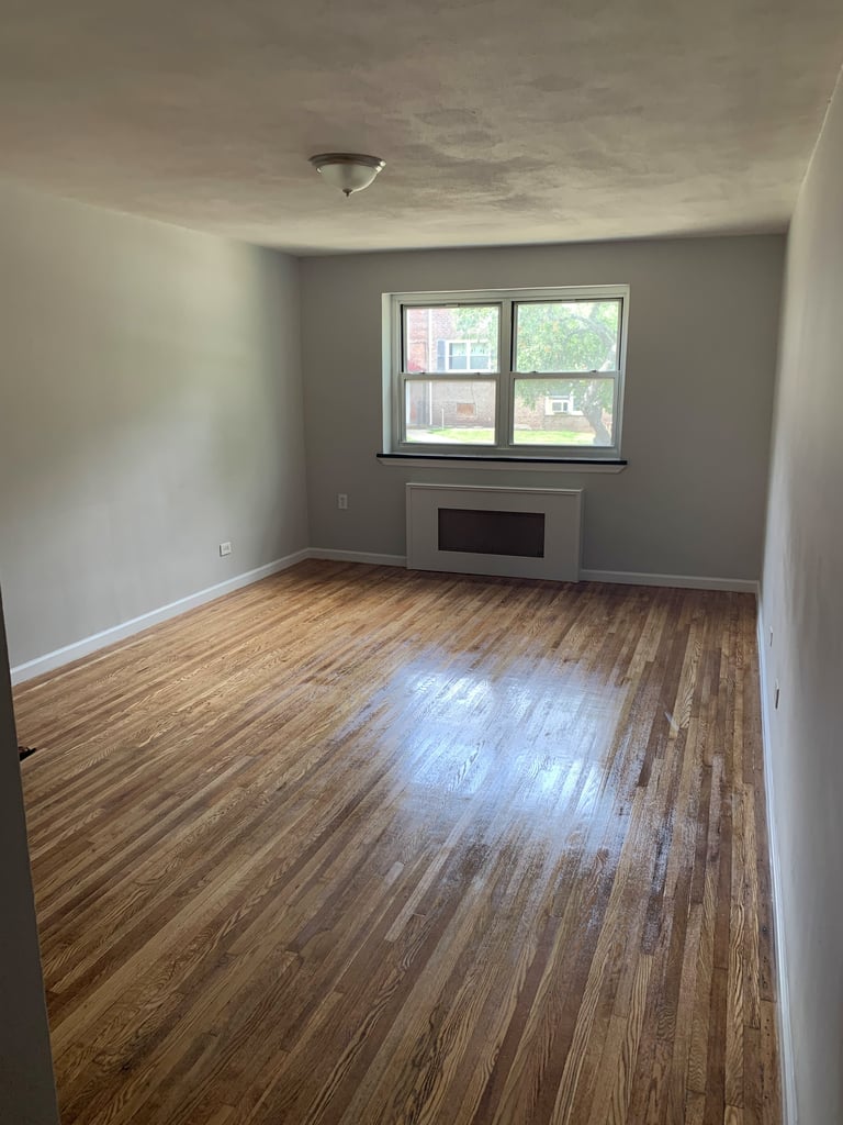 Living room in Queens with large windows