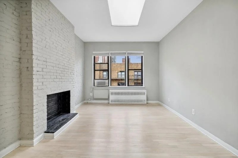 Manhattan studio with exposed brick fireplace