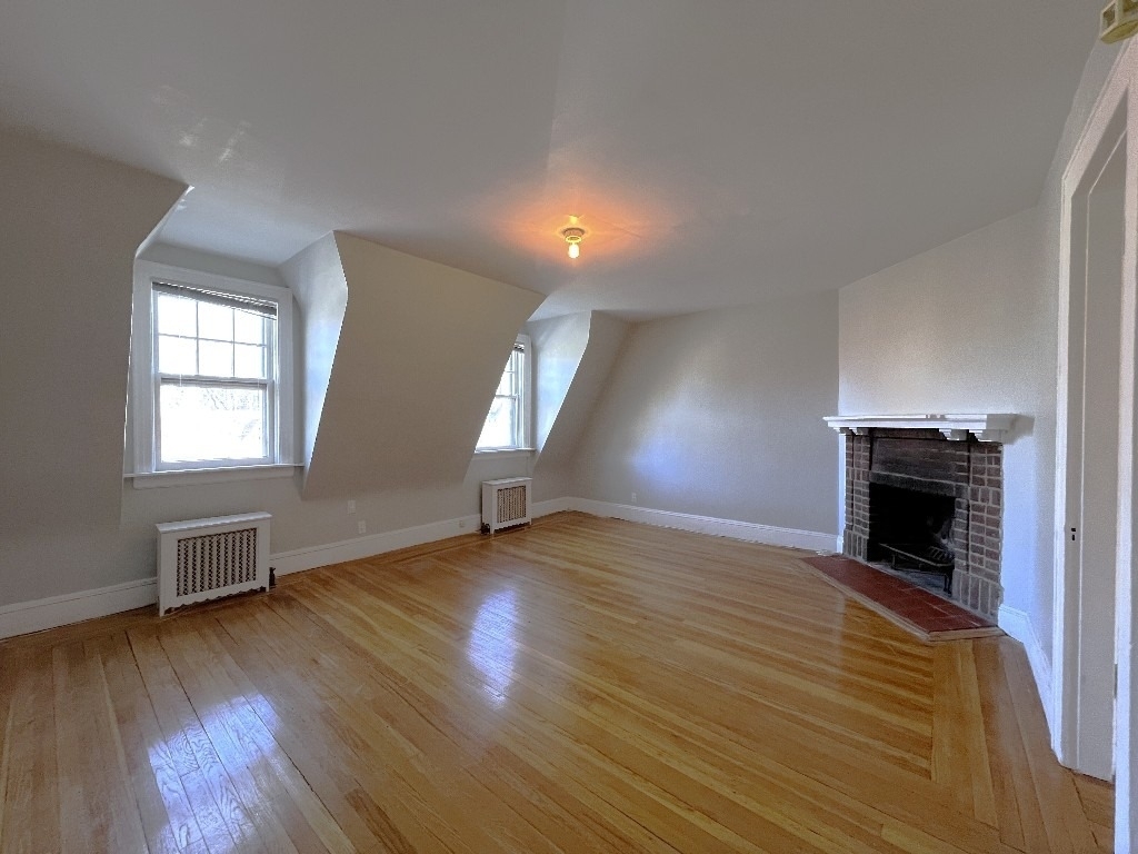 Living room with a fireplace in Queens apartment in March 2025