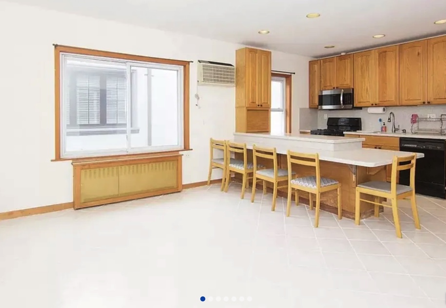 apartment listing photo of empty kitchen and room